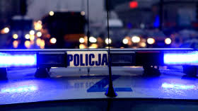 Zdjęcie przedstawia dach policyjnego radiowozu z włączonymi sygnałami świetlnymi barwy niebieskiej - pojazdu uprzywilejowanego